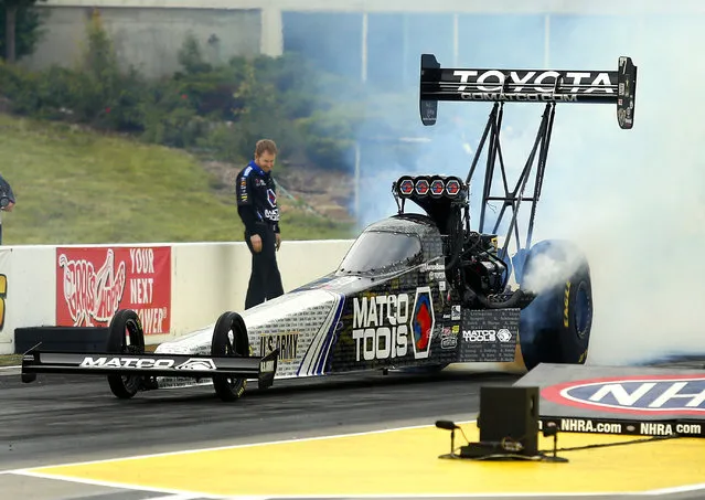 Antron Brown does a burnout during a Top Fuel session at NHRA Kansas Nationals drag races Friday May 22, 2015, at Heartland Park in Topeka, Kan. Brown finished the day as the top qualifier. (Photo by Chris Neal/The Topeka Capital-Journal via AP Photo)