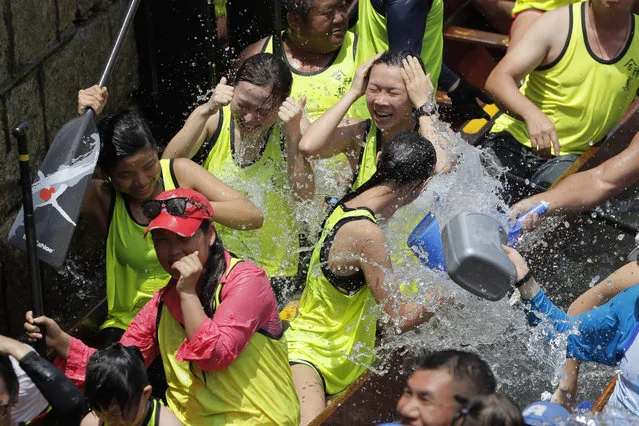 Participants splash water from their dragon boat as part of celebrations marking the Chinese Dragon Boat Festival, held throughout Hong Kong, Friday, June 7, 2019. Dragon boat races are in remembrance of Chu Yuan, an ancient Chinese scholar-statesman, who drowned in 277 B.C. while denouncing government corruption. (Photo by Kin Cheung/AP Photo)