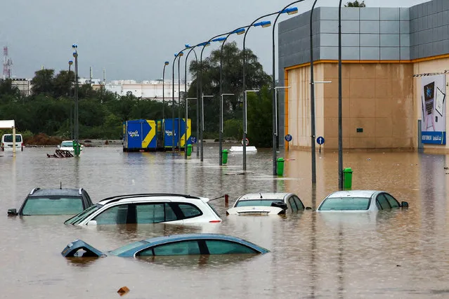 This picture taken on January 4, 2022 shows a view of completely flooded cars in a parking lot outside a shopping centre in Oman's capital Muscat. Bad weather has been affecting states around the Gulf, with several issuing weather warnings. (Photo by Mohammed Mahjoub/AFP Photo)