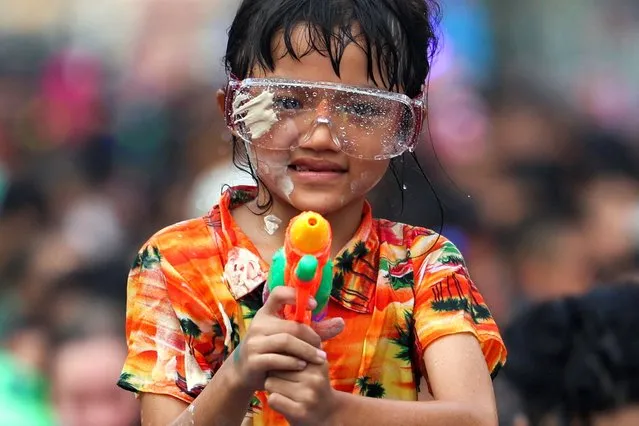 A girl with white powder on her face celebrates the Songkran holiday which marks the Thai New Year in Bangkok, Thailand, on April 14, 2024. (Photo by Chalinee Thirasupa/Reuters)