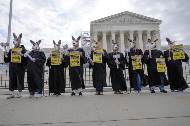 Demonstrators stand outside the Supreme Court as the justices prepare to hear arguments over whether Donald Trump is immune from prosecution in a case charging him with plotting to overturn the results of the 2020 presidential election, on Capitol Hill Thursday, April 25, 2024, in Washington. (Photo by Mariam Zuhaib/AP Photo)