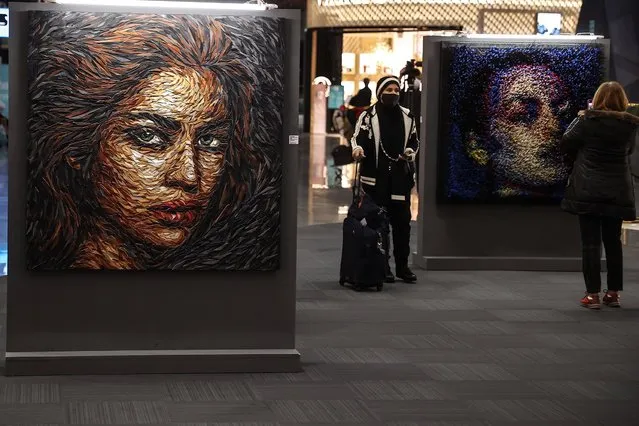 A portrait made with waste materials such as old uniforms, buttons, plastic boxes and bags collected at Istanbul Airport by artist Deniz Sagdic are being displayed at Istanbul Airport's International Departures in Istanbul, Turkey on January 12, 2022. (Photo by Onur Coban/Anadolu Agency via Getty Images)