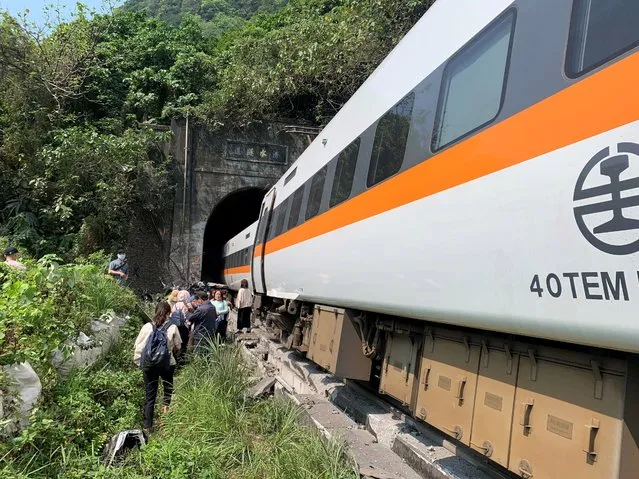 This handout picture taken and released by on April 2, 2021 by Taiwan's Central Emergency Operation Center shows the scene of where a train derailed inside a tunnel in the mountains of Hualien, eastern Taiwan. (Photo by Handout/Central Emergency Operation Center/AFP Photo)