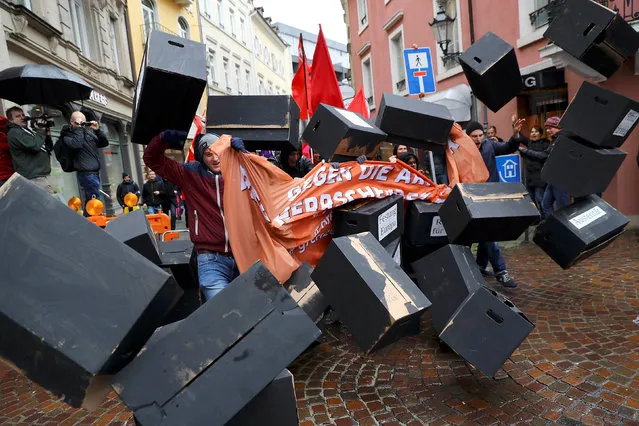 Protestors break through a symbolic wall as they demonstrate against the G20 Finance Ministers and Central Bank Governors Meeting in Baden-Baden, Germany, March 18, 2017. (Photo by Kai Pfaffenbach/Reuters)