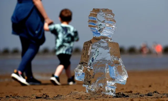 Ice sculptures of children created by Sand in Your Eye to highlight the importance of COP26, the global climate conference, are seen at New Brighton Beach on the Wirral peninsular in New Brighton, Britain on May 31, 2021. (Photo by Jason Cairnduff/Reuters)