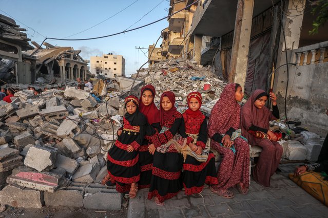 Palestinians gather to perform Eid al-Adha prayer among the rubble of buildings destroyed by Israeli forces, as the Israeli attacks and blockades continue in Khan Yunis, Gaza on June 16, 2024. (Photo by Ali Jadallah/Anadolu via Getty Images)