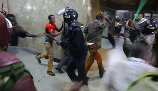 Kenyan policemen beat protesters during clashes in Nairobi, Kenya May 16, 2016. (Photo by Goran Tomasevic/Reuters)