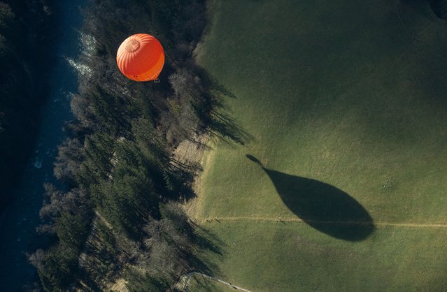 A balloon takes part in the 44th International Hot Air Balloon Festival in Chateau-d'Oex, Switzerland on January 25, 2024. (Photo by Denis Balibouse/Reuters)