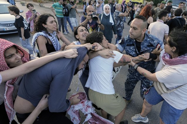 Protesters clash with troops and riot police during a demonstration near the Egyptian embassy in Beirut, Lebanon, Monday, May 27, 2024, in solidarity with the Palestinian people in Gaza and demanding the Egyptian authorities open the Rafah border crossing between Egypt and the Gaza Strip. (Photo by Bilal Hussein/AP Photo)