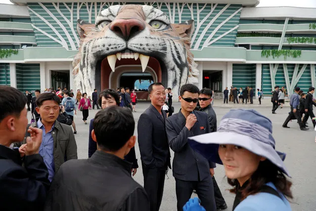 People gather at the entrance of a zoo in Pyongyang, North Korea on April 17, 2017. (Photo by Damir Sagolj/Reuters)