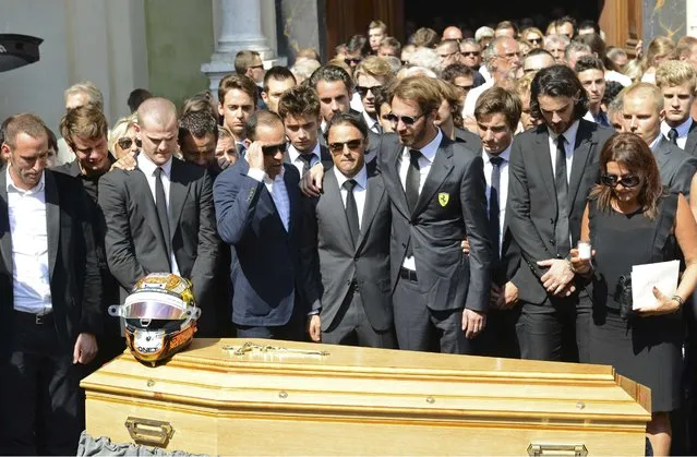 Formula One drivers Jean-Eric Vergne (4thR) and Felipe Massa (C), friends and relatives gather around the coffin of late Marussia F1 driver Jules Bianchi during the funeral ceremony at the Sainte Reparate Cathedral in Nice, France, July 21, 2015. Bianchi, 25, died in hospital in Nice on Friday, nine months after his crash at Suzuka in Japan and without regaining consciousness. (Photo by Jean-Pierre Amet/Reuters)