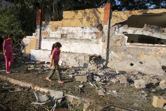 Palestinian girl walk at the site of an Israeli strike, outside a school sheltering displaced people, amid Israel-Hamas conflict, in Khan Younis in the southern Gaza Strip on July 10, 2024. (Photo by Hatem Khaled/Reuters)