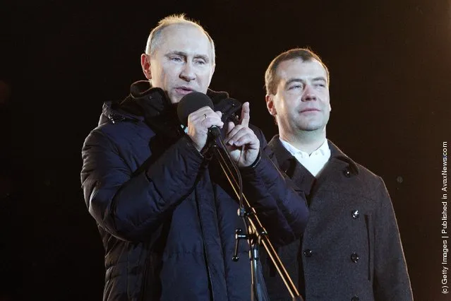 Russian Prime Minister and presidential candidate Vladimir Putin speaks as current President Dmitry Medvedev (R) listens during a rally after Putin claimed victory in the presidential election at the Manezhnya Square March, 4, 2012 in Moscow, Russia