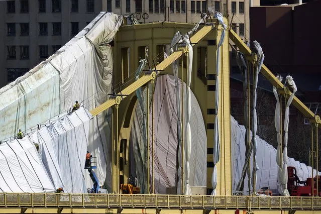Workers prepare the Roberto Clemente bridge for refurbishing in downtown Pittsburgh on Tuesday, April 12, 2022. The project is expected to be completed by Dec. 2023. (Photo by Gene J. Puskar/AP Photo)