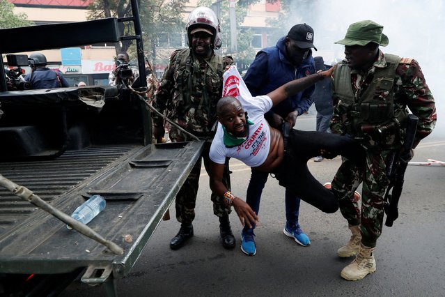 Police detains Kenyan activist Boniface Mwangi during an anti-government demonstration following nationwide deadly riots over tax hikes and a controversial now-withdrawn finance bill, in Nairobi, Kenya, on July 25, 2024. (Photo by Thomas Mukoya/Reuters)