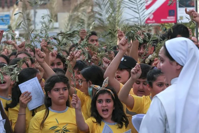 Iraqi Christians gather at Saint Joseph's church in Arbil, the capital of the autonomous Kurdish region of northern Iraq, on April 9, 2022, to celebrate Palm Sunday marking the triumphant return of Christ to Jerusalem the week before his crucifixion when a cheering crowd greeted him waving palm leaves, according to Christian tradition. (Photo by Safin Hamed/AFP Photo)