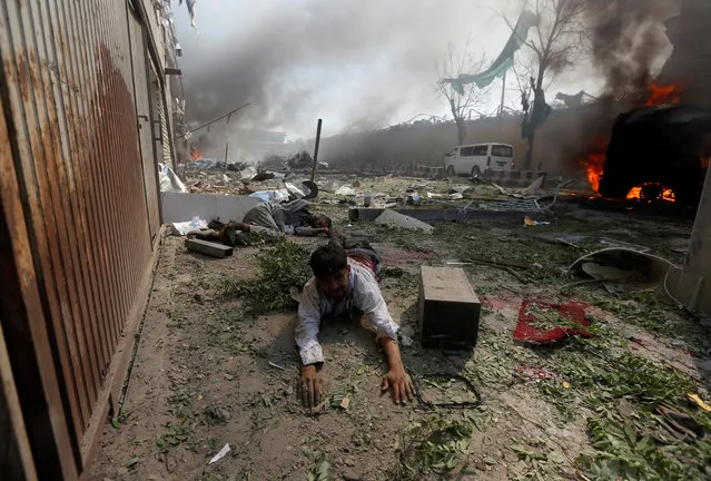 A wounded man lies on the ground at the site of a blast in Kabul, Afghanistan May 31, 2017. (Photo by Omar Sobhani/Reuters)