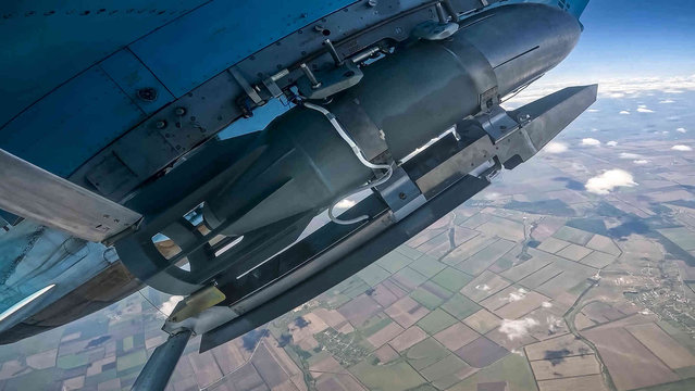 In this photo taken from video released by Russian Defense Ministry Press Service on Wednesday, July 3, 2024, a glide bomb is seen under the wing of a Su-34 bomber of the Russian air force during a combat mission in Ukraine. The Russian military has increasingly relied on glide bombs that can be launched at a safe distance from Ukraine's air defenses to strike Ukrainian positions. (Photo by Russian Defense Ministry Press Service via AP Photo)