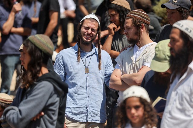 A man reacts, as friends and family mourn 17-year-old Nachman Shmuel Mordoff, who was killed in a Palestinian shooting attack along with three other Israelis near the Jewish settlement of Eli, at his funeral in Shilo in the Israeli-occupied West Bank on June 21, 2023. (Photo by Nir Elias/Reuters)