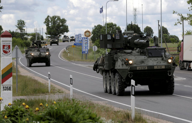 U.S. troops cross the Lithuanian-Latvian border during tactical road march Dragoon Ride II in Subate, Latvia, June 6, 2016. (Photo by Ints Kalnins/Reuters)