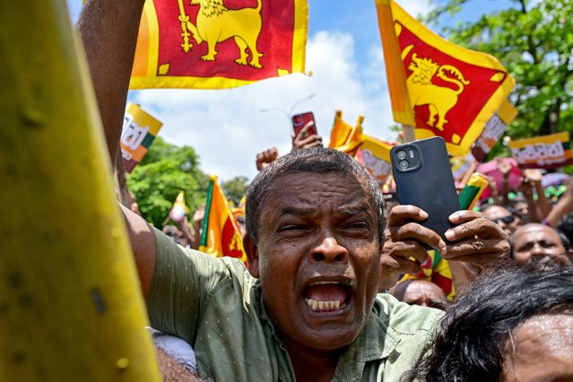 Supporters of Sri Lanka's President and United National Party presidential candidate Ranil Wickremesinghe (not pictured), cheer as he leaves the Election Commission office after filing his nomination papers for the upcoming presidential elections, in Colombo on August 15, 2024. Sri Lanka's first presidential elections since an unprecedented economic crisis spurred widespread unrest will be held in September, the election commission said on July 26. (Photo by Ishara S. Kodikara/AFP Photo)