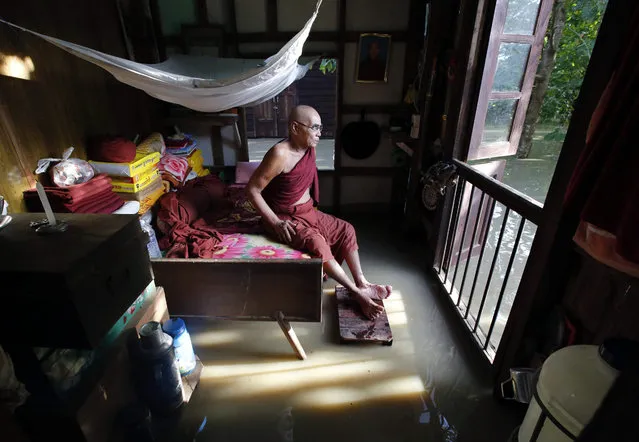 A 70-year-old Myanmar Buddhist monk sits on his bed inside a half-flooded monastery in Nyaung Don township of Ayeyarwaddy Region, Myanmar, 05 August 2015. Myanmar's president declared four regions of the country as disaster zones on 31 July 2015. Heavy monsoon rains caused floods around Myanmar with dozens deaths being reported as thousands are fleeing their homes in several regions across the country. (Photo by Lynn Bo Bo/EPA)