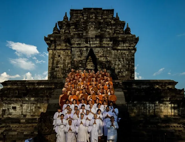 Buddhist monks pose for a photo session after holy water ritual at Mendut temple on May 15, 2022 in Magelang, Indonesia. Vesak is observed during the full moon in May or June with the ceremony centering around three Buddhist temples, pilgrims walk from Mendut to Pawon, ending at Borobudur. The holy day celebrates the birth, the enlightenment to nirvana, and the passing of Gautama Buddha, the founder of Buddhism. (Photo by Robertus Pudyanto/Getty Images)