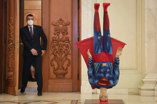 A mannequin depicting Superman is placed upside down next to the door of the parliament session hall hosting a no confidence vote agains Romanian Prime Minister Florin Citu's government in Bucharest, Romania, Tuesday, October 5, 2021. Romania's government fell after 281 lawmakers of the 234 required voted in favor of the no-confidence vote. (Photo by Vadim Ghirda/AP Photo)