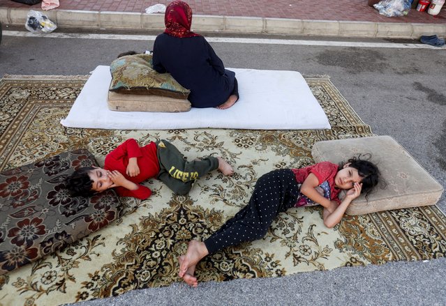 Syrian refugees, who fled from southern Lebanon villages due to ongoing hostilities between Hezbollah and Israeli forces, take shelter in a parking lot in Sidon, Lebanon on September 30, 2024. (Photo by Aziz Taher/Reuters)