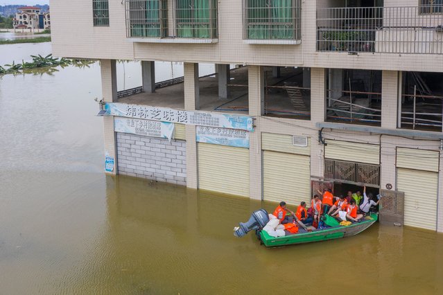 Volunteers use a boat to evacuate stranded villagers in the flood water on June 22, 2022 in Qingyuan, Guangdong Province of China. Flood control authority of China's Guangdong Province activated a Level-I emergency response on Tuesday. (Photo by Qiu Xinsheng/VCG via Getty Images)
