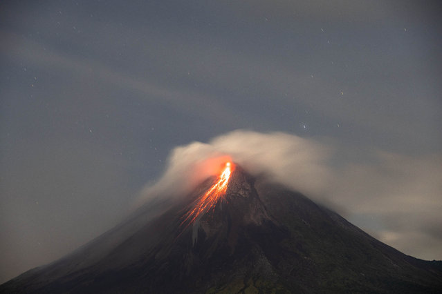 Lava runs down from the crater of Mount Merapi as the volcanic activity increases, as seen from Turgo village in Sleman Regency, Yogyakarta Province, Indonesia, on September 14, 2024. The most active volcano is on the Java island; Mount Merapi stands 2,968 meters (9,738 feet) tall. (Photo by Garry Lotulung/Anadolu via Getty Images)