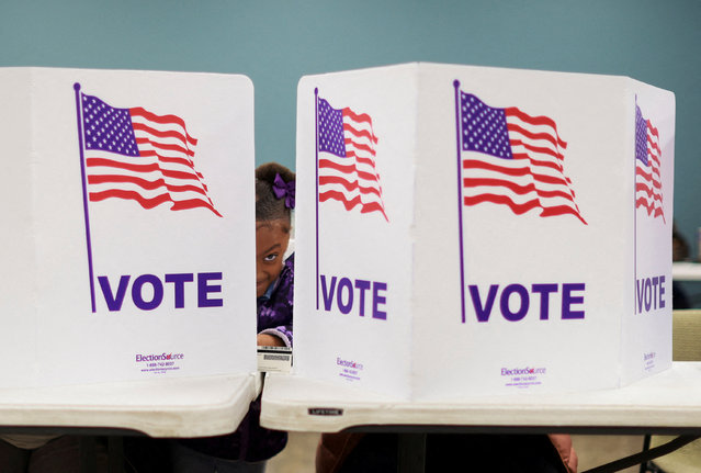 Lavish James accompanies her mother during voting in the 2024 U.S. presidential election on Election Day in First Christian Reformed Church in Grand Rapids, Michigan, U.S., November 5, 2024. (Photo by Carlos Osorio/Reuters)