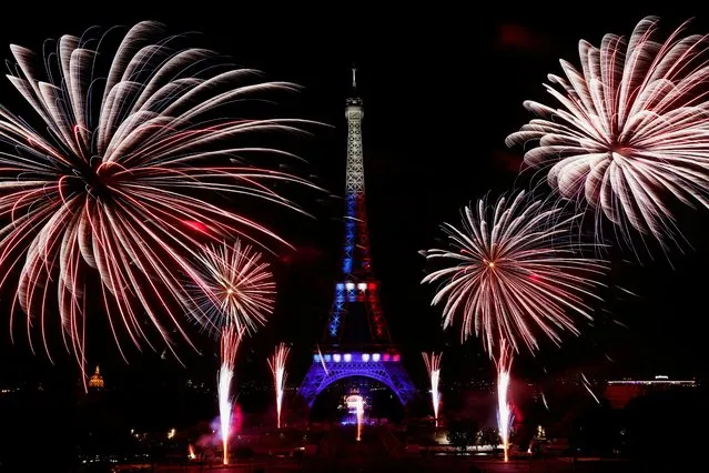 Fireworks explode around the Eiffel Tower during celebrations to mark Bastille Day, in Paris, France, July 14, 2022. (Photo by Benoit Tessier/Reuters)