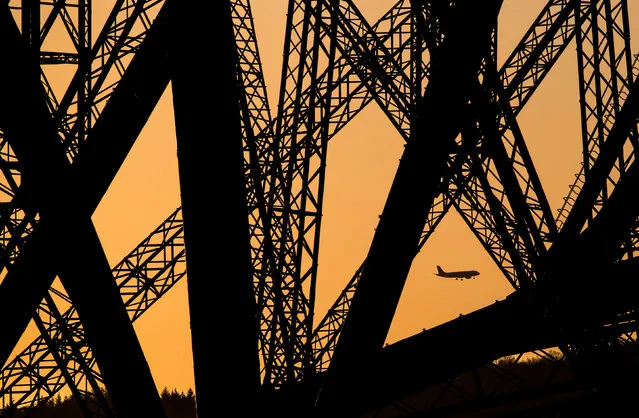A plane flying on March 2, 2020 over Edinburgh is framed in the structure of the Forth Bridge, North Queensferry. (Photo by Jane Barlow/PA Images via Getty Images)