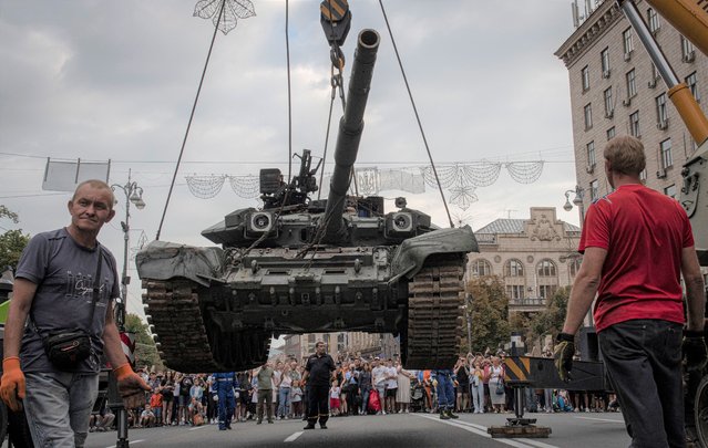 Ukrainians visit an avenue where destroyed Russian military vehicles have been displayed in Kyiv, Ukraine, Saturday, August 20, 2022. (Photo by Andrew Kravchenko/AP Photo)