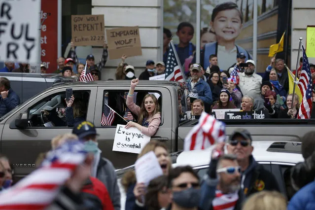 Protesters demonstrate at the state Capitol in Harrisburg, Pa., Monday, April 20, 2020, demanding that Gov. Tom Wolf reopen Pennsylvania's economy even as new social-distancing mandates took effect at stores and other commercial buildings. (Photo by Matt Slocum/AP Photo)