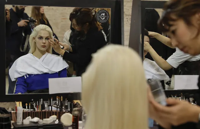 Models make up in the backstage prior to the start of the Ujoh women's Spring-Summer 2018 fashion show, that was presented in Milan, Italy, Monday, September 25, 2017. (Photo by Luca Bruno/AP Photo).