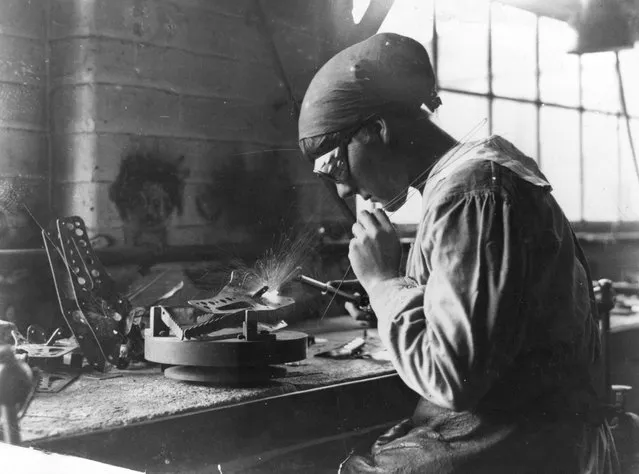 A woman munitions worker welds at a work bench in an armaments factory, 1915. (Photo by Hulton Archive)