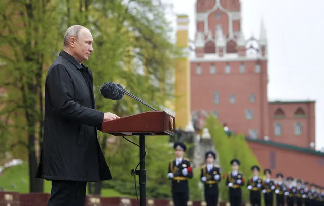 Russian President Vladimir Putin addresses the nation from the Tomb of the Unknown Soldier at the Kremlin wall marking the 75th anniversary of the Nazi defeat in World War II in Moscow, Russia, Saturday, May 9, 2020. Putin cancelled a massive Victory Day marking the 75th anniversary of the Nazi defeat in World War II but ordered a flyby of warplanes over Red Square. (Photo by Alexei Druzhinin, Sputnik, Kremlin Pool Photo via AP Photo)