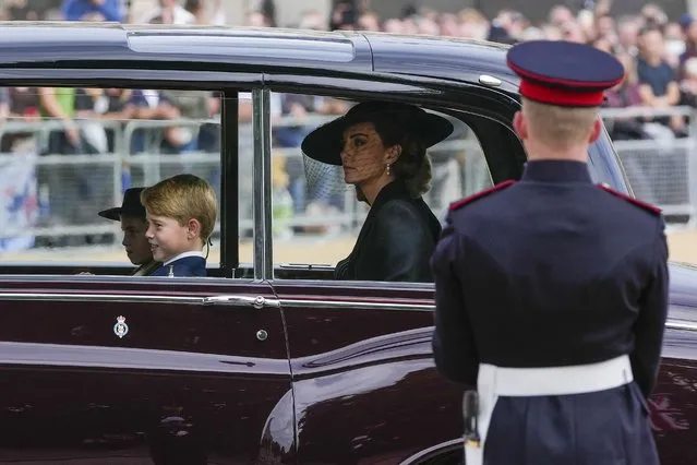 Kate, Princess of Wales and her children Prince George and Princess Charlotte ride in a car behind the coffin of Queen Elizabeth II as it is pulled on a gun carriage through the streets of London following her funeral service at Westminster Abbey, Monday September 19, 2022.The Queen, who died aged 96 on Sept. 8, will be buried at Windsor alongside her late husband, Prince Philip, who died last year. (Photo by Kin Cheung/AP Photo/Pool)