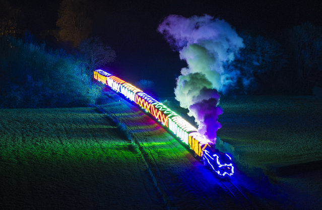 A Bluebell Railway locomotive, decorated with thousands of coloured Christmas lights, steams towards Horsted Keynes station in West Sussex, UK on November 30, 2023. Passengers visiting the heritage railway line can enjoy the SteamLights event between Sheffield Park and Horsted Keynes stations. (Photo by Peter Macdiarmid/London News Pictures)