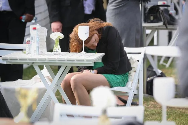 This woman also appears to be taking a power nap during Caulfield Cup Day at Caulfield Racecourse on October 21, 2017 in Melbourne, Australia. (Photo by Splash News and Pictures)