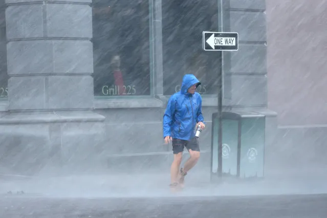 A pedestrian navigates a driving rain from Hurricane Ian on September 30, 2022 in Charleston, South Carolina. Ian hit Florida as a category 4 storm causing widespread damage as it crossed the state before moving into the Atlantic and hitting South Carolina as a category 1 storm near Charleston. (Photo by Scott Olson/Getty Images)