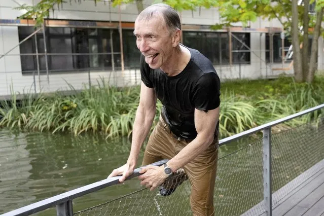Swedish scientist Svante Paabo climbs out of a pool after his colleagues threw him into it, outside the Max Planck Institute for Evolutionary Anthropology in Leipzig, Germany, Monday, October 3, 2022. Swedish scientist Svante Paabo was awarded the 2022 Nobel Prize in Physiology or Medicine for his discoveries on human evolution. (Photo by Hendrik Schmidt/dpa via AP Photo)