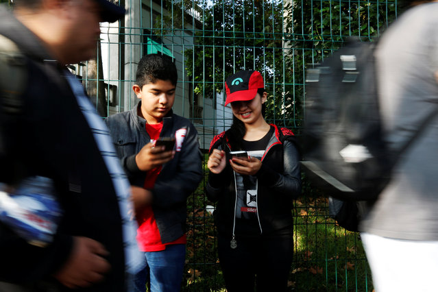 Young people play Pokemon Go during a gathering to celebrate “Pokemon Day” in Mexico City, Mexico August 21, 2016. (Photo by Carlos Jasso/Reuters)