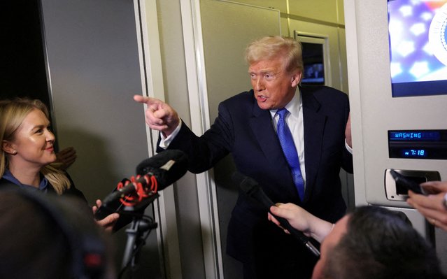 U.S. President Donald Trump speaks to reporters as White House Press Secretary Karoline Leavitt stands with him aboard Air Force One on his return to Washington on March 9, 2025. (Photo by Kevin Lamarque/Reuters)