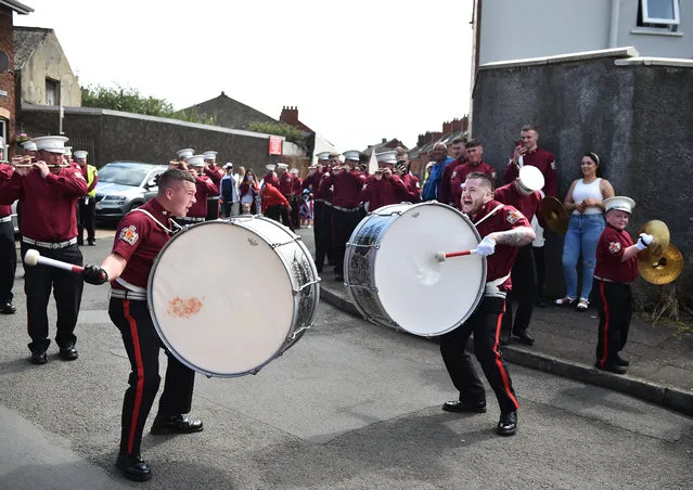 Loyalist and protestant band members take part in a socially distanced Twelfth parade on the Shankill road on July 13, 2020 in Belfast, Northern Ireland. Most Twelfth of July parades, which celebrate the 1690 defeat of Catholic King James II by the Protestant William of Orange, were cancelled in April amid the UK coronavirus lockdown. Now, groups of up to 30 people are allowed to meet outdoors while social distancing, and many parades planned to resume under those conditions. (Photo by Charles McQuillan/Getty Images)