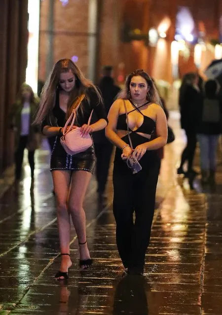Young ladies hit the streets of Manchester, England on December 31, 2017 despite the inclement weather hitting the city. (Photo by Eamonn and James Clarke)