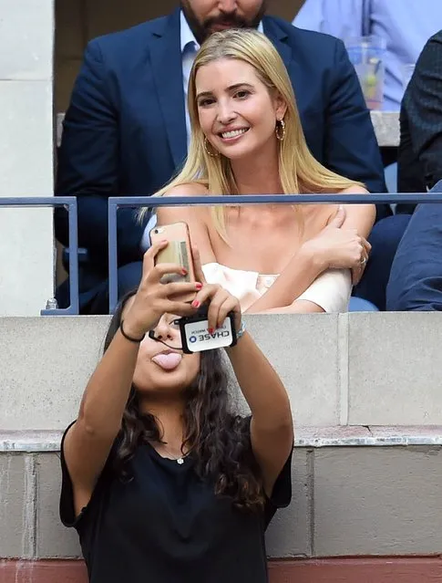 A girl takes a photo with Ivanka Trump (back), daughter of US Republican presidential candidate Donald Trump, during the 2016 US Open Men's Singles final match between Novak Djokovic of Serbia and Stan Wawrinka of Switzerland at the USTA Billie Jean King National Tennis Center in New York on September 11, 2016. (Photo by Jewel Samad/AFP Photo)
