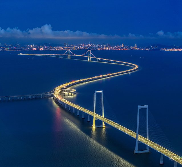 Night view of Shenzhen-Zhongshan link, a megaproject consisting of two bridges, two artificial islands, and an underwater tunnel on July 12, 2024 in Zhongshan, Guangdong Province of China. Shenzhen-Zhongshan link, as a core transportation hub project in the Guangdong-Hong Kong-Macao Greater Bay Area, opened to traffic on June 30. (Photo by Wang Meiyan/VCG via Getty Images)